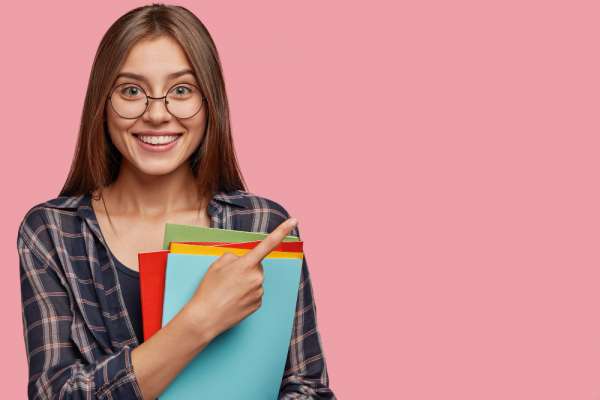 studio-shot-good-looking-young-businesswoman-posing-against-pink-wall-with-glasses