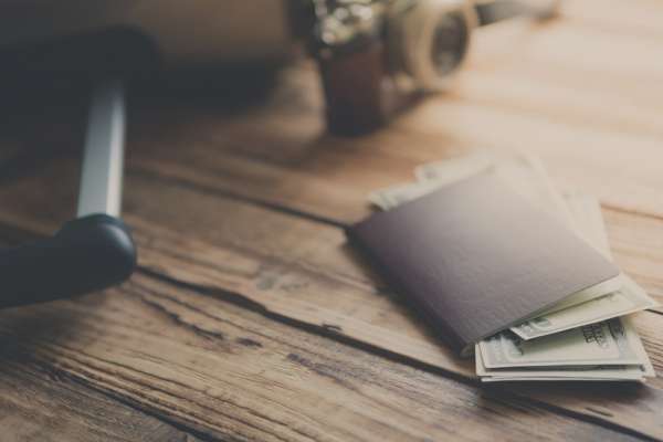 close-up-passport-with-bills